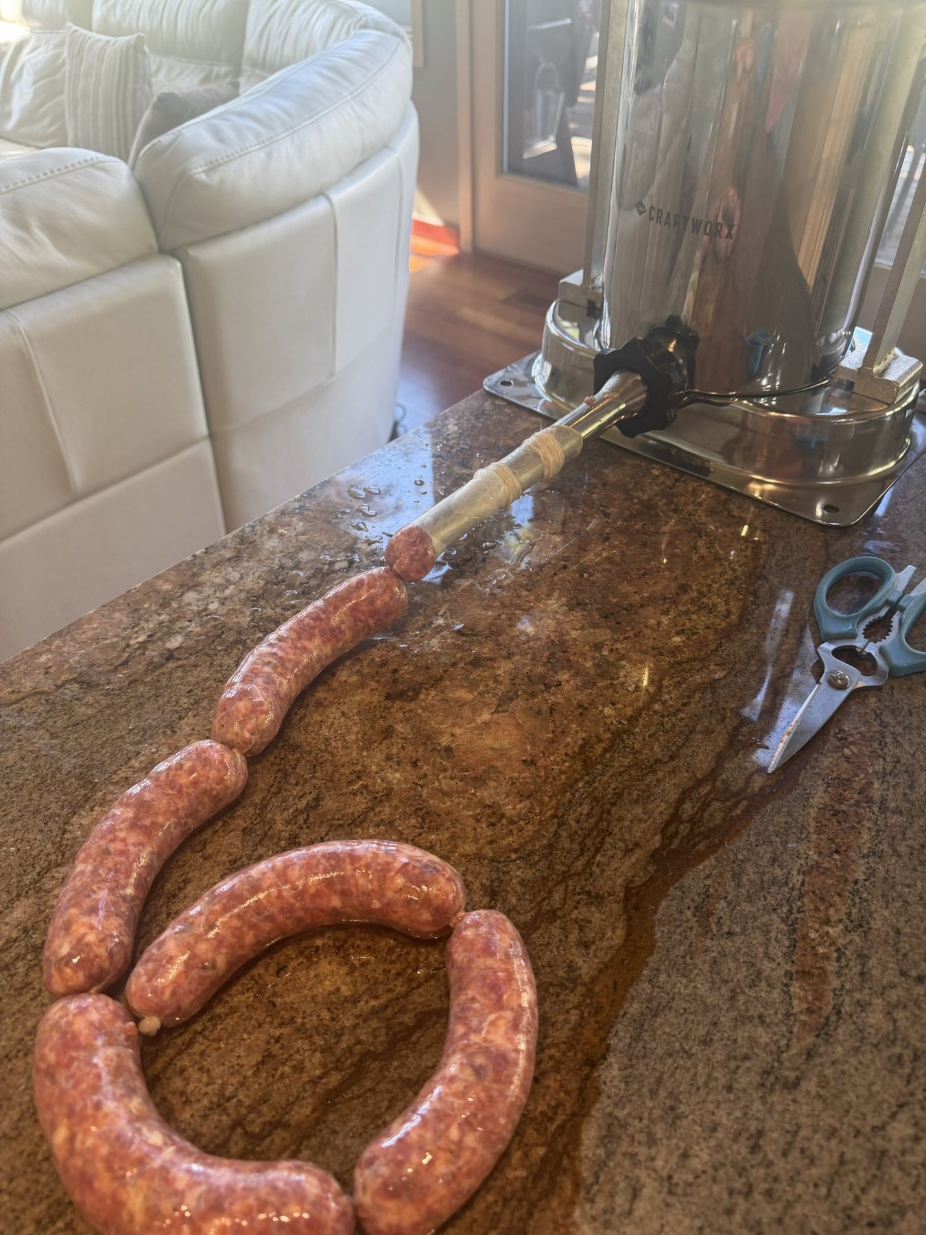 House-made sausage being stuffed into natural casings